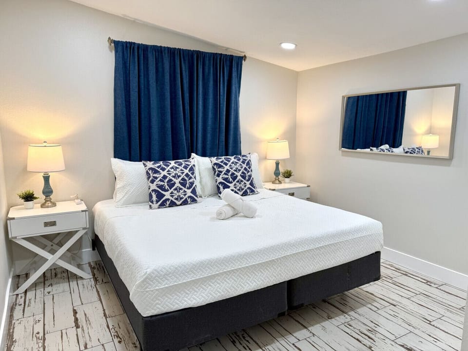 King bedroom with soft lighting and fresh linens