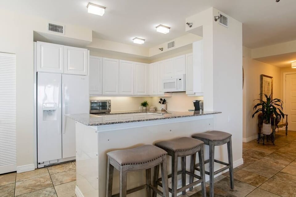The kitchen opens to the den with more seating 