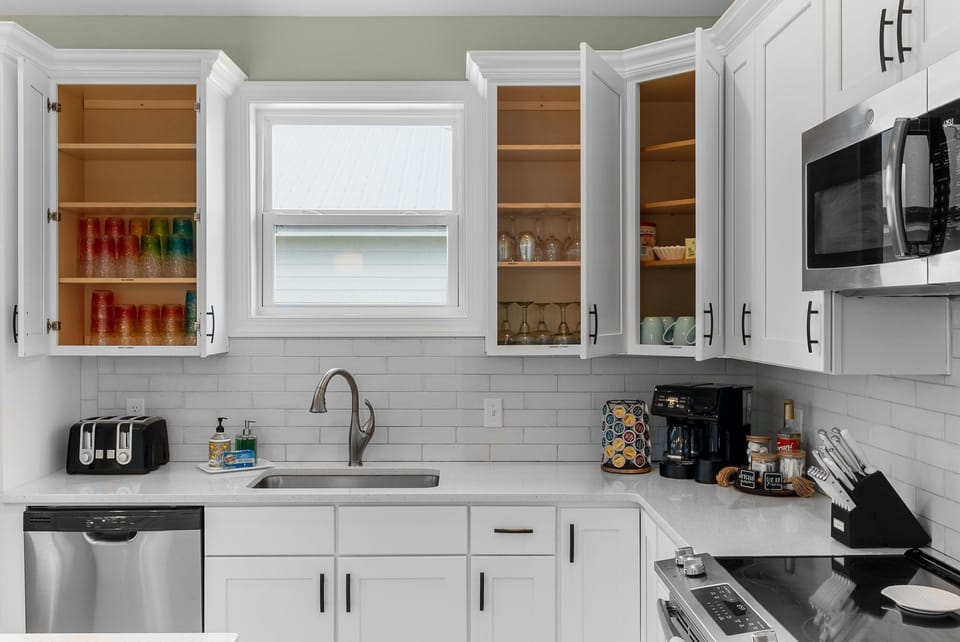 The kitchen is loaded with everything you need - cups, glasses, coffee bar, etc.