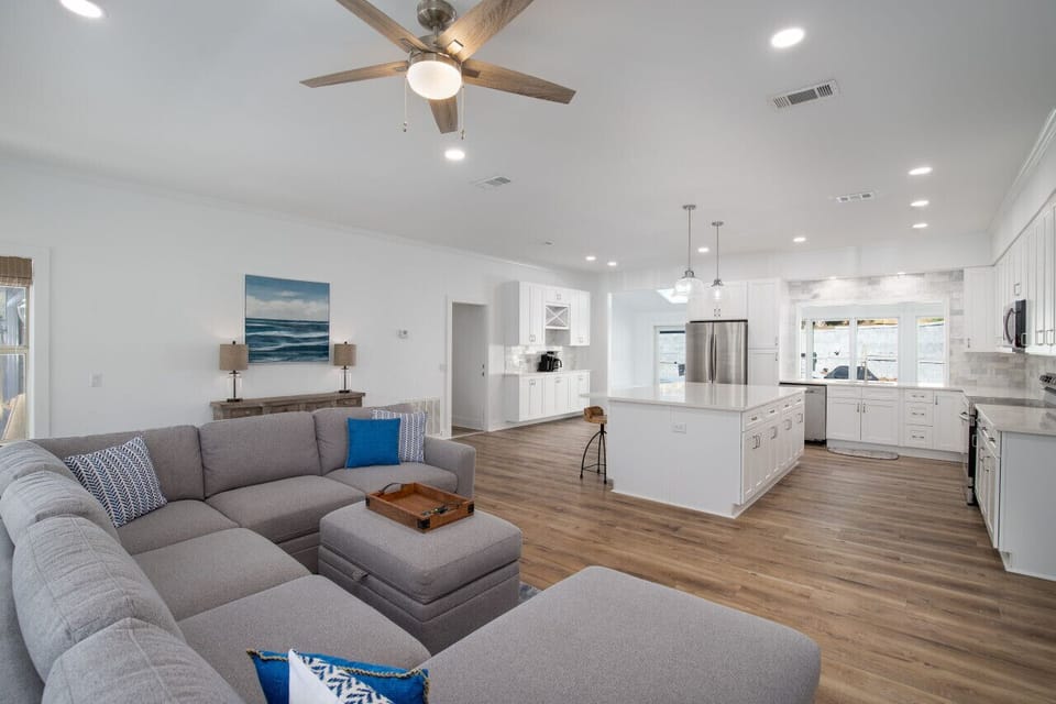 Living area open to the bright, airy kitchen.