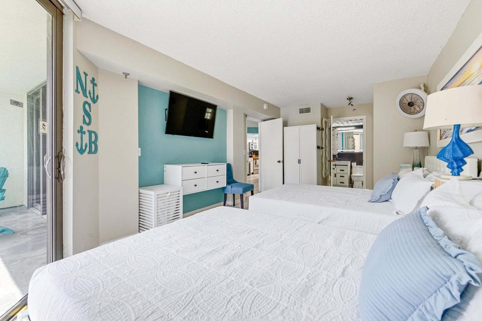 The bedroom is equipped with two queen-sized beds.