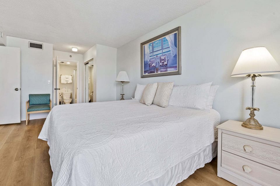 Enjoy restful nights in this bright king bedroom with soft coastal décor and plenty of space