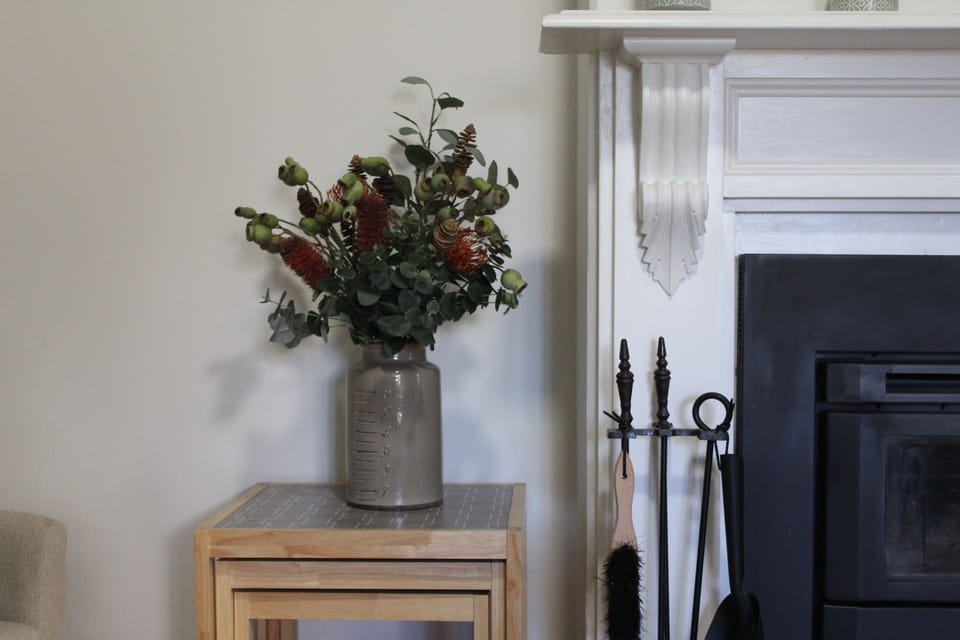 Lounge room has slow combustion fire with wood provided in winter.