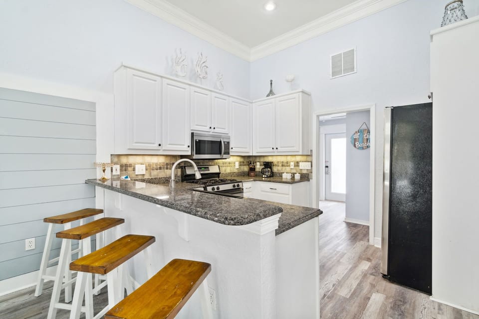Gas Stove Kitchen with Island and Extra Refrigerator off the Kitchen