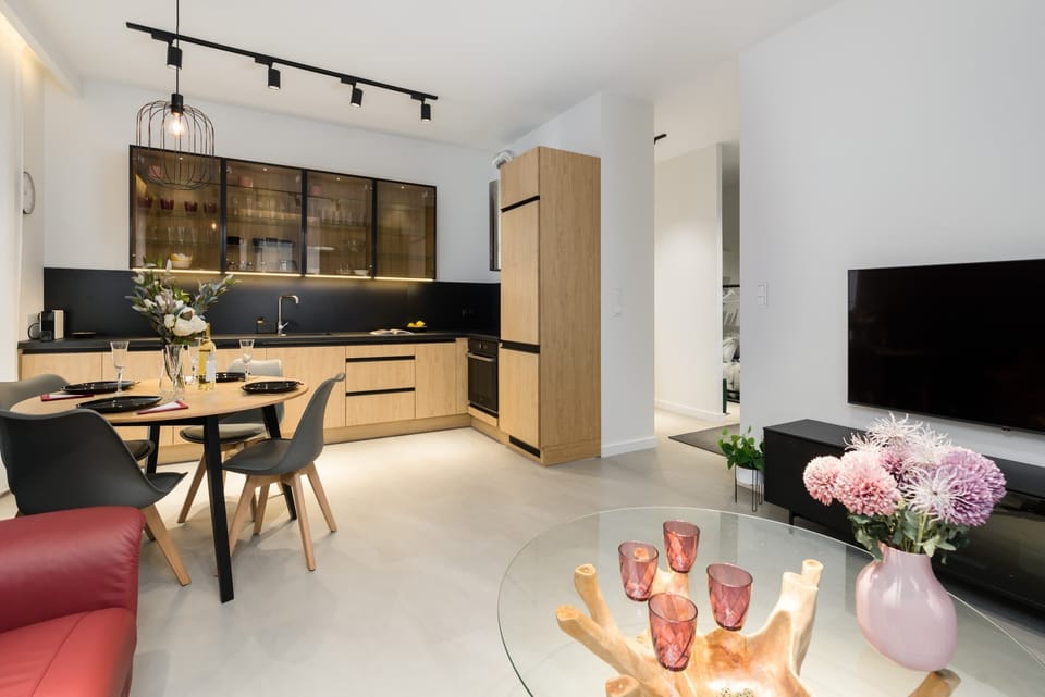 A dining area with a wooden table and comfortable chairs.
