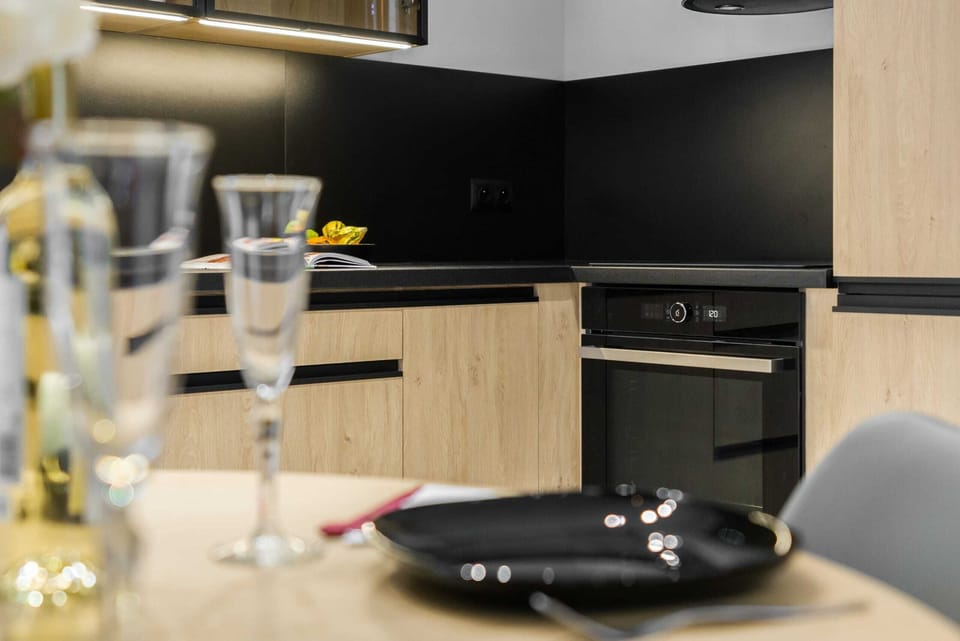 A kitchen setup with a dining table and glassware on display.
