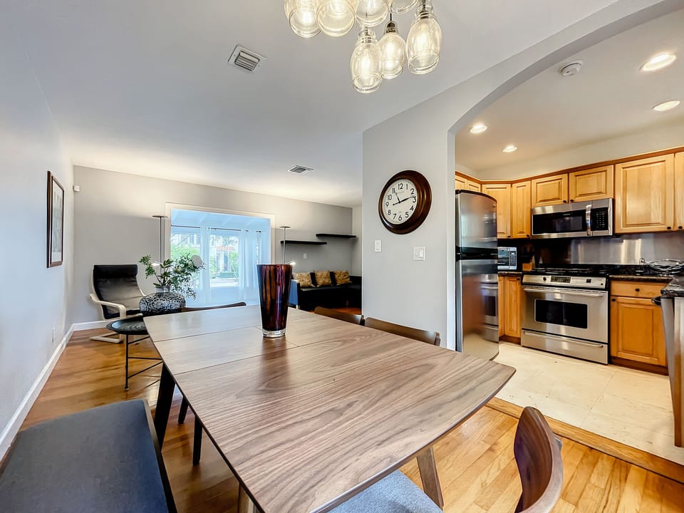 Dining area in the foreground, kitchen in the background 