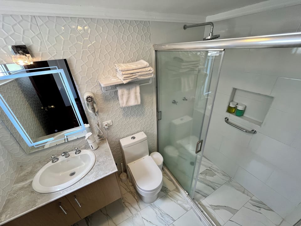 Superior Room | Bathroom | Hair dryer, towels, soap, shampoo