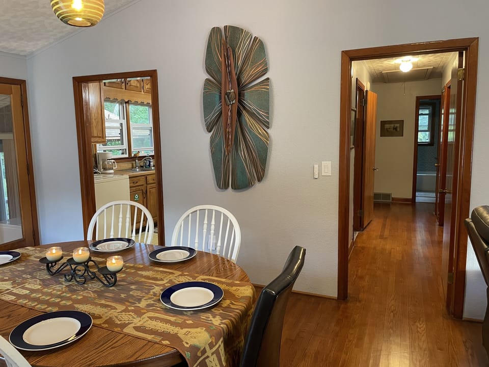 Dining area with view down the hall to bedrooms and bathroom.