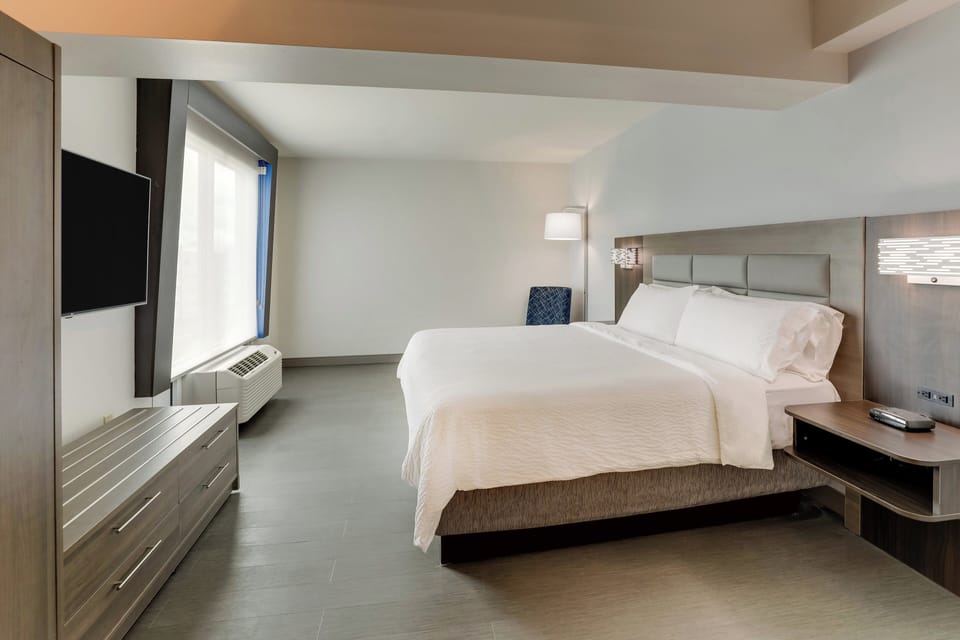 Premium bedding, desk, laptop workspace, blackout drapes