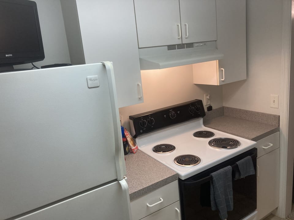 Kitchen. TV, stove. Dishwasher, sink, coffee maker and microwave are behind me.