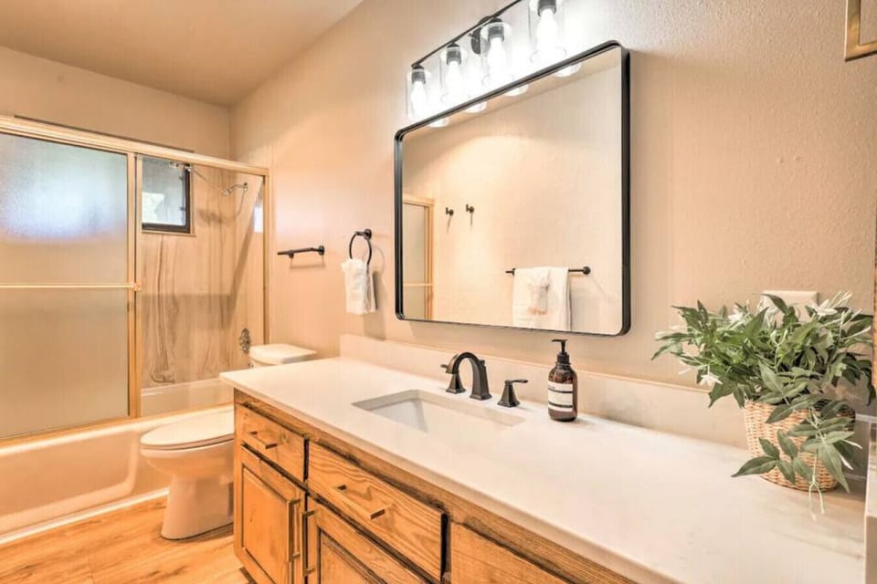 Downstairs full bath of the hall.  Shower/tub combo.