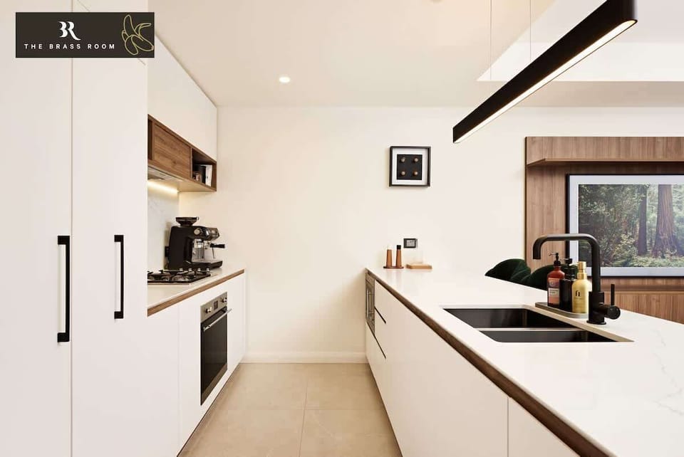 Our fully equipped kitchen features modern appliances including a fully automatic espresso and a spacious layout, perfect for cooking and entertaining.