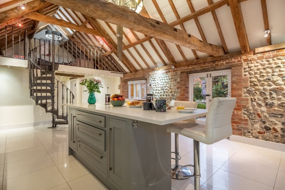 Ground floor main barn: A spiral staircase leads to the mezzanine study area