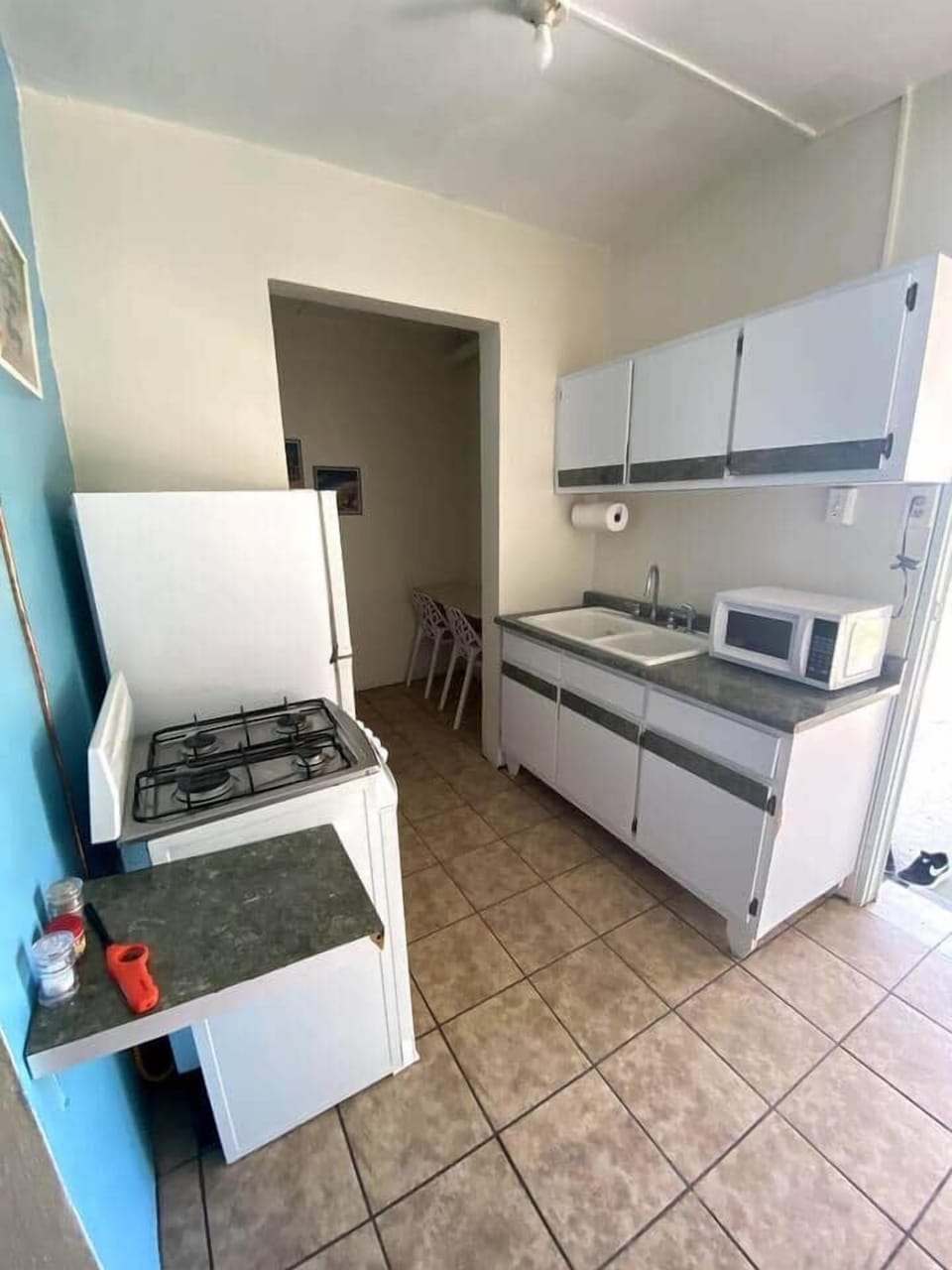 Equipped kitchen with a refrigerator, gas stove, microwave, coffee pot and utensils for cooking and small breakfast area for 2.