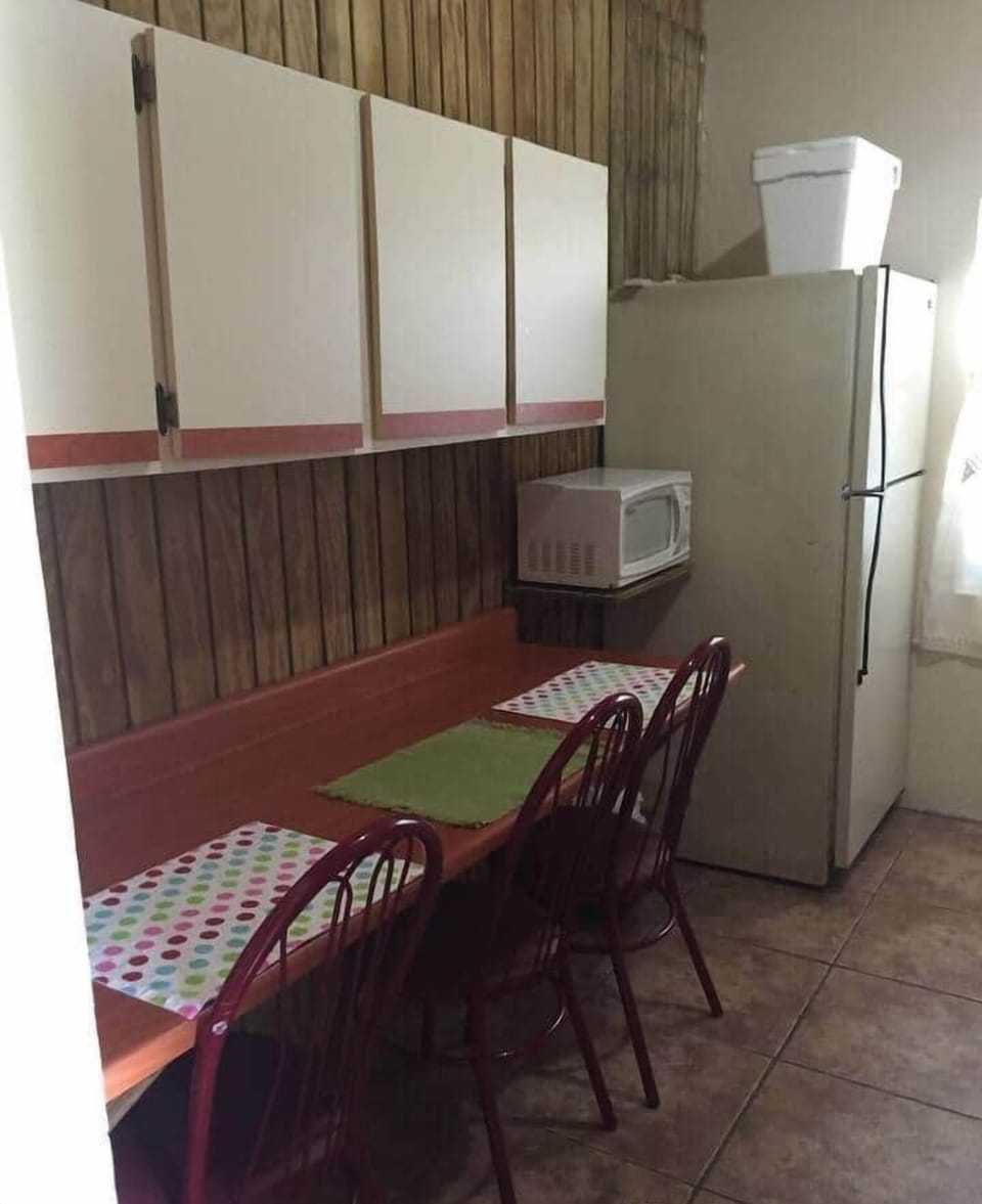 A equipped kitchen with a sitting breakfast area.