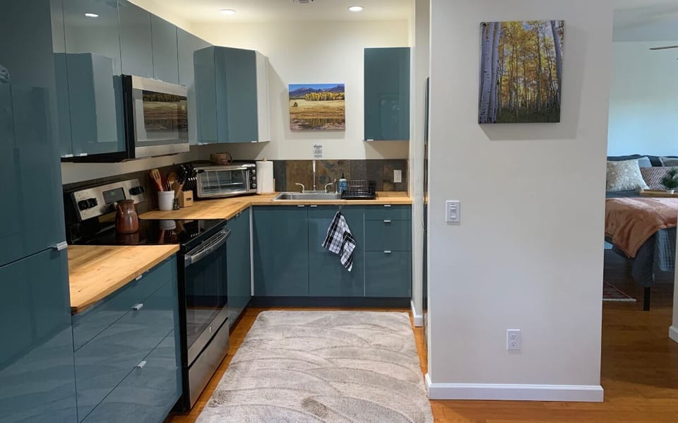 Kitchen has full sized fridge (not shown). Entry to bedroom on the right. 