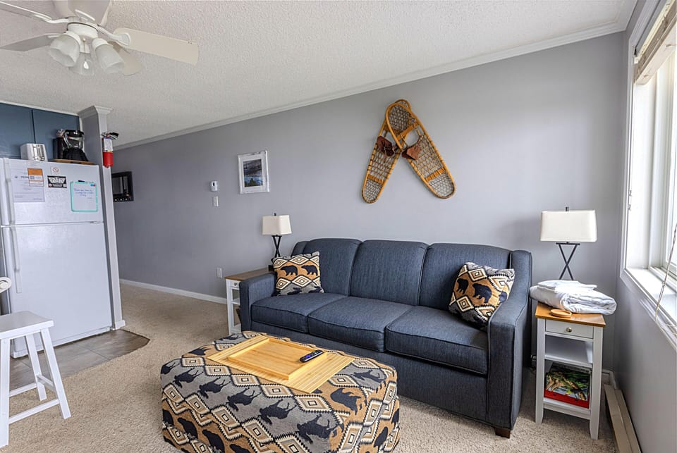 Snuggle up in the comfy sofa bed and enjoy the mountain views and unwind while watching the 59" TV.