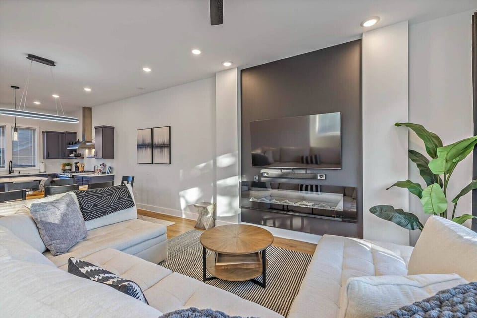 Living room boasts a 65` Smart TV, Hi-fi soundbar with sub, electric fireplace, monster sofa couch with huge pull-out sleeper
