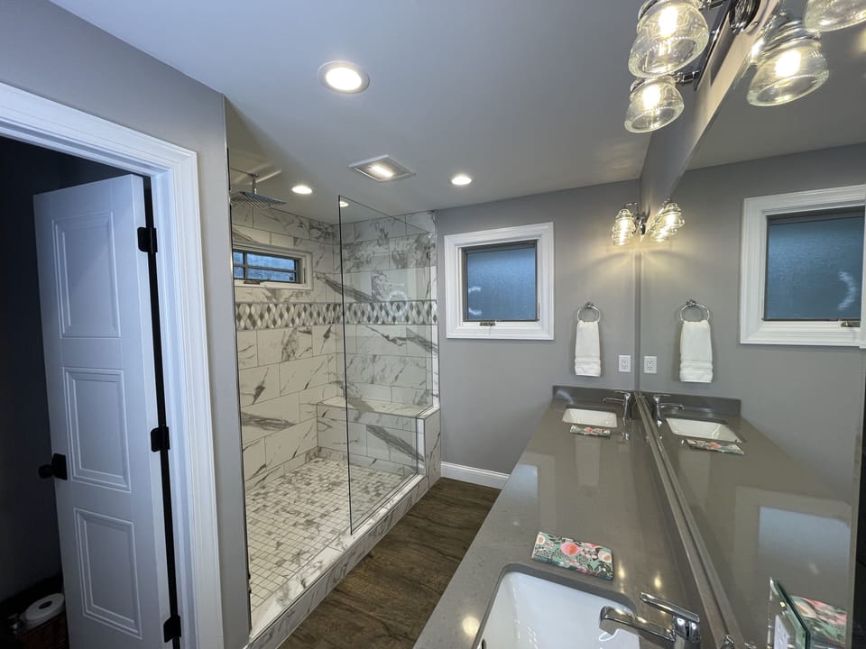 Master Bath has large vanity and mirror, dual  sinks, and rain head shower