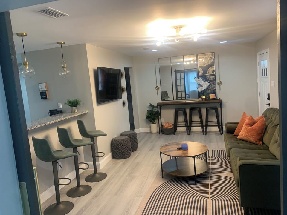 Living room with Smart TV and access to the lounge space, kitchen & bedrooms.