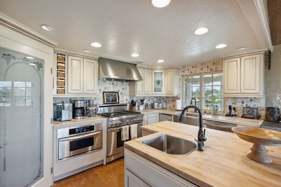 Kitchen with gas range, microwave, warming drawer and built in refrigerator..