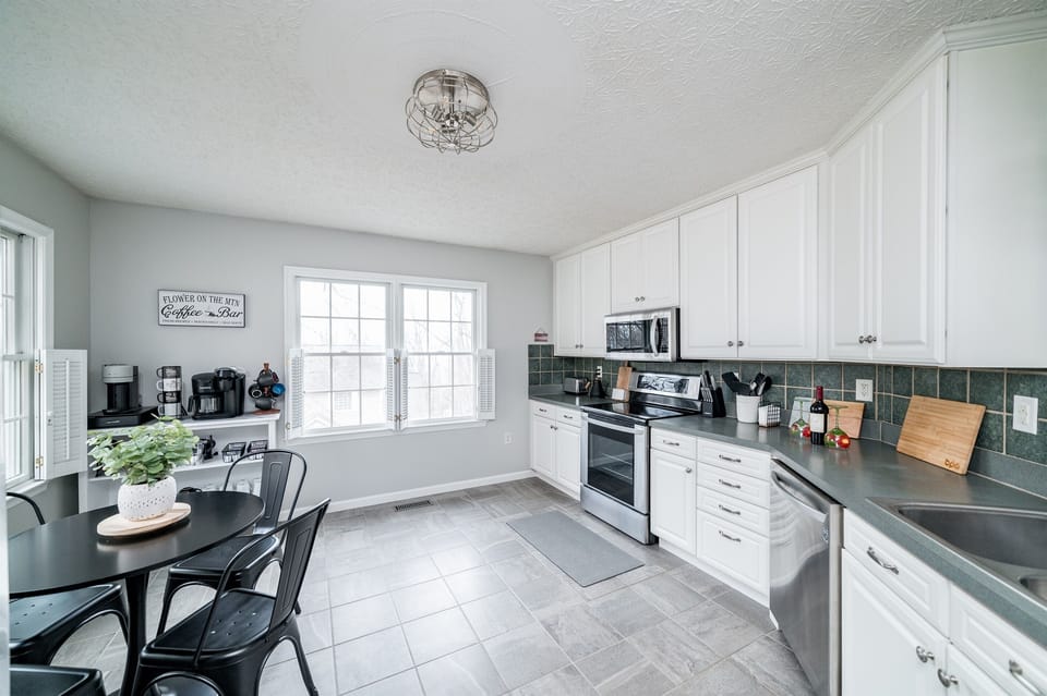 The fully loaded kitchen in Flower on the Mountain has a charming bistro table with seating for four making it an ideal spot for intimate conversations over breakfast or lunch.