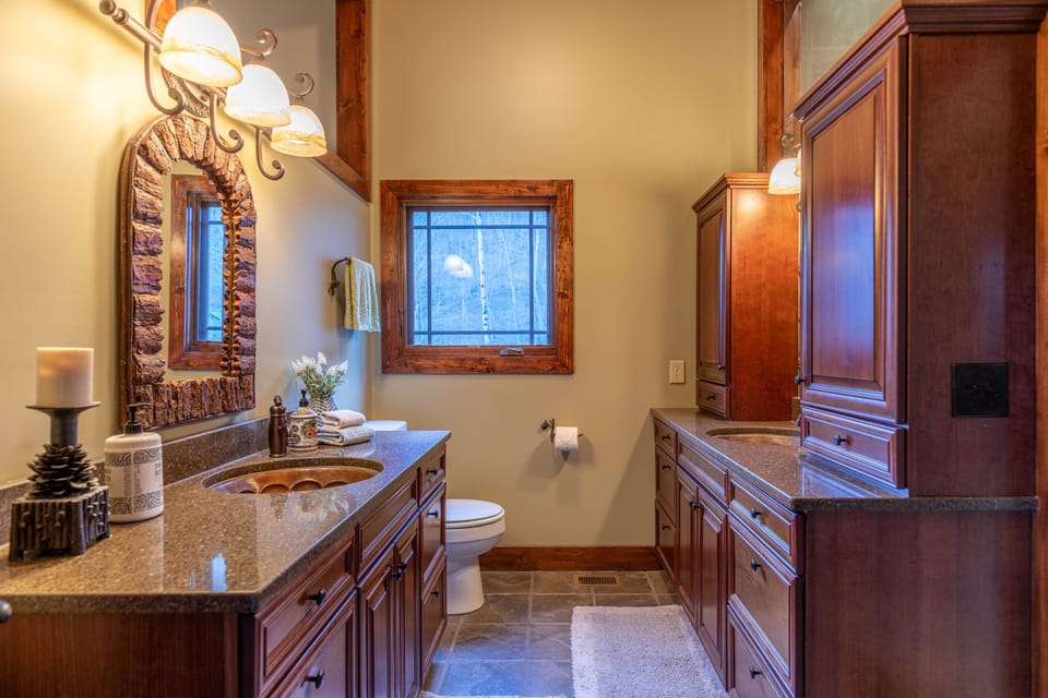 Rustic elegance meets everyday comfort, dual vanities and handcrafted details make getting ready feel like part of the retreat.