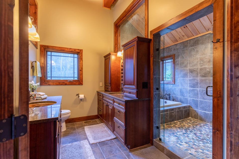 Spa-worthy finishes at Elk Island At River Run. Slate tile, a soaking tub, and warm wood cabinetry make unwinding easy.