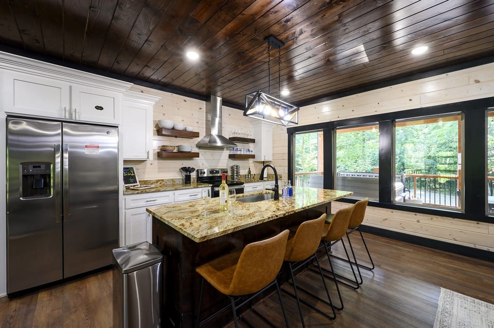 The well-equipped kitchen, which includes an oven, sink, and a large island, will be perfect for cooking big meals for your group.