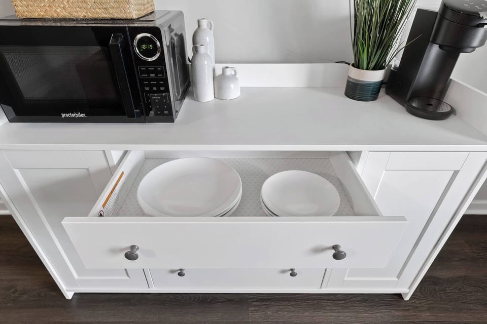 Beautiful ceramic plates, cups, and bowls are located inside the drawer, ready for those lovely breakfast, lunch, or dinner!