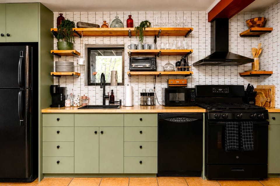 Prepare breakfast using the gas range and light wood countertops and the white tile backsplash is easy to clean after prepping meals for a group.