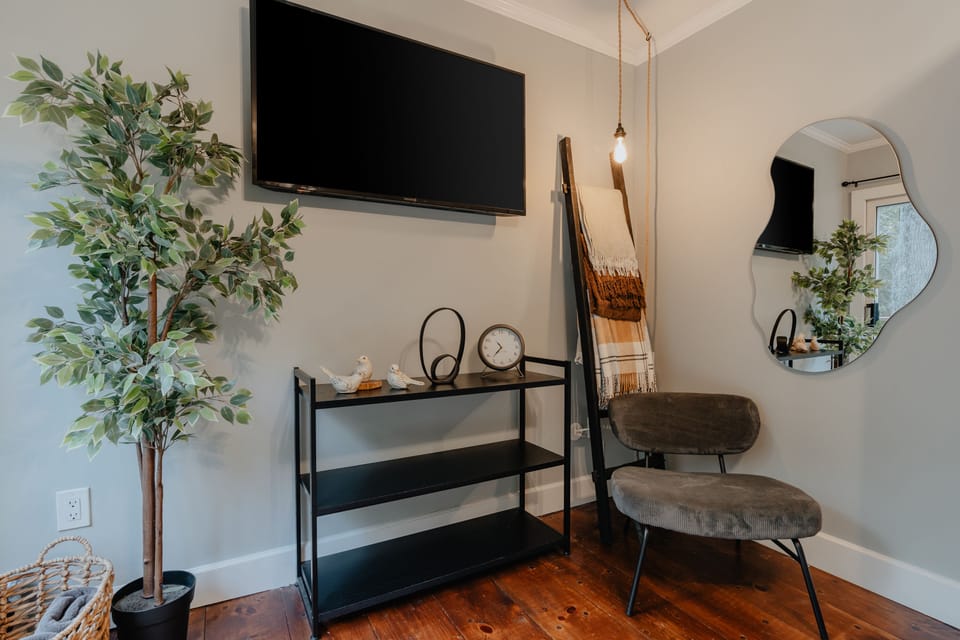 The primary bedroom has a nice seating area for lounging. There is also a large smart TV for all your streaming needs.
