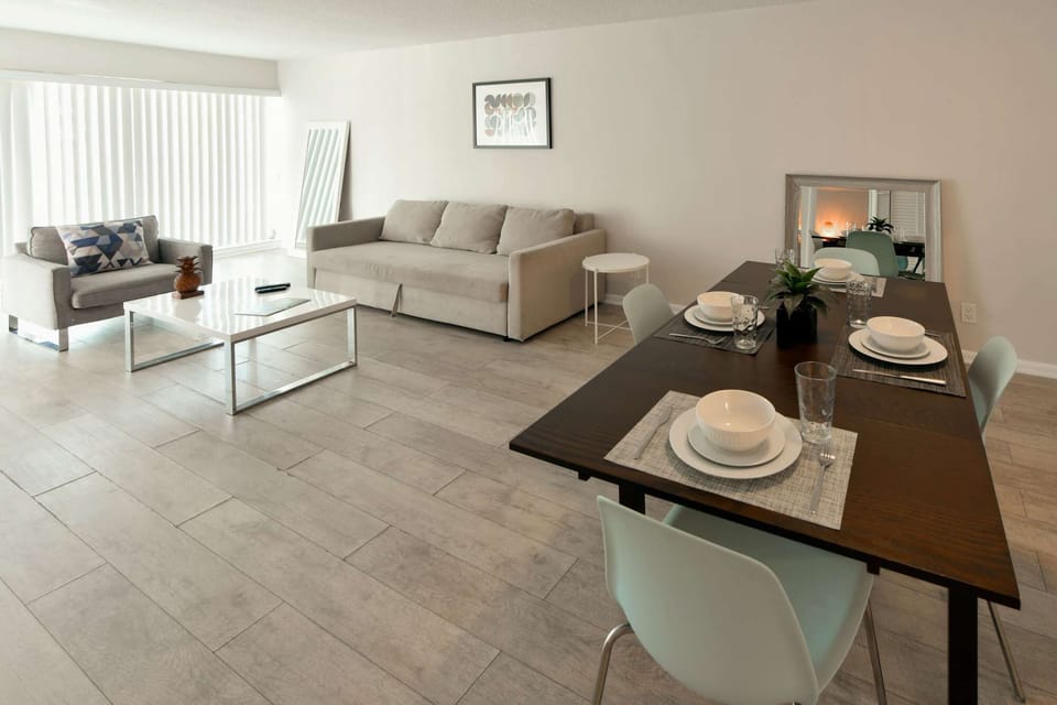 Open dining and living area with sofa, chair, and table