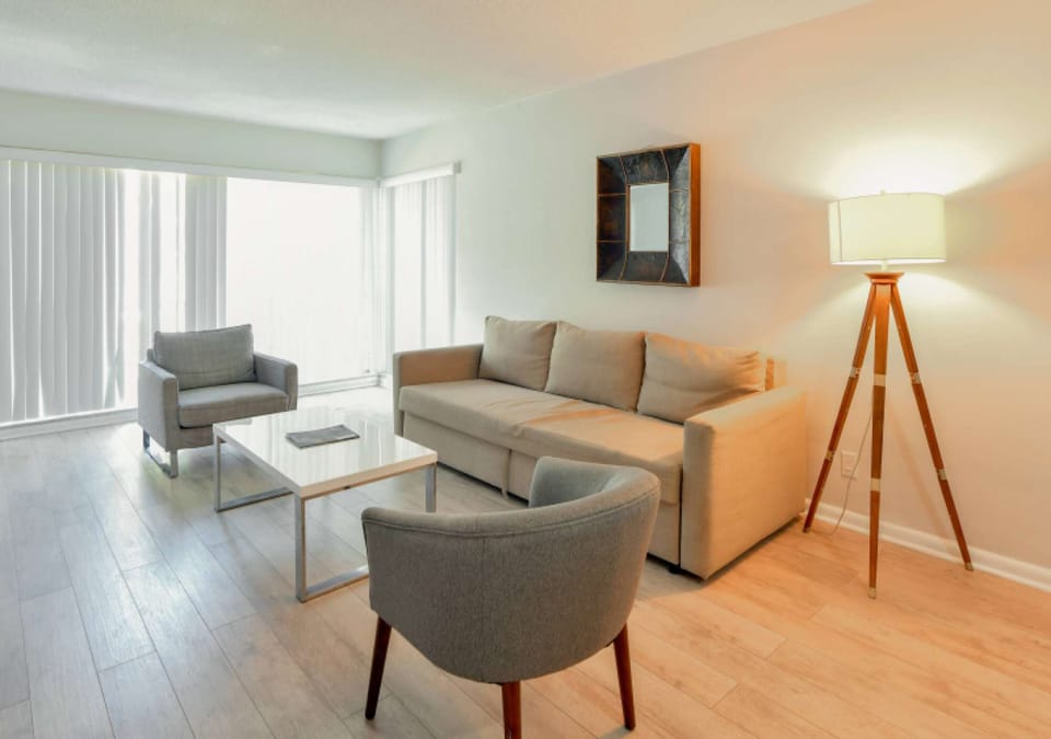 Sitting area with sofa, chairs, table, and floor lamp