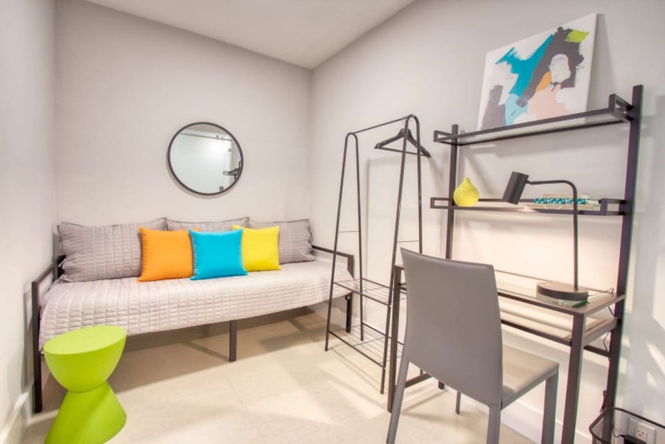 Sitting area with daybed, desk, chair, and colorful pillows