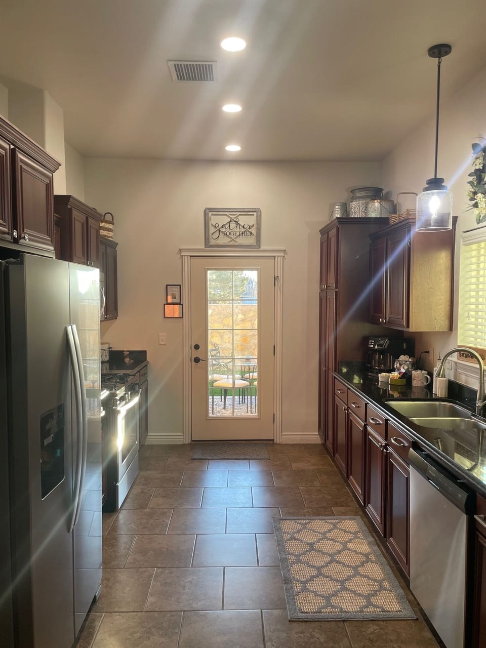 Kitchen with new, update lighting and a view of the back patio