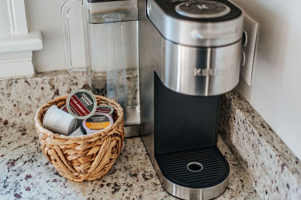 Keurig with K cups, creamer and sugar provided