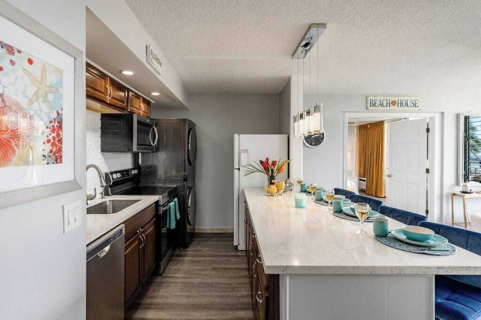 The kitchen is filled with all the amenities any aspiring chef could want! The washer and dryer sit on top of one another to make the best use of the space. A full sized sink, electric stove and oven, and also a microwave make for a tidy kitchen. 