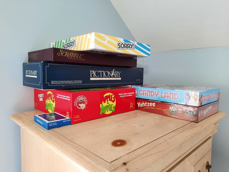 Assortment of family games. Including a fold up table to use (next to cabinet)!
