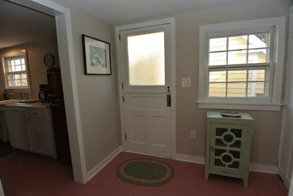 Back door with mud room.  Storage closet w/ beach chairs and cleaning supplies.
