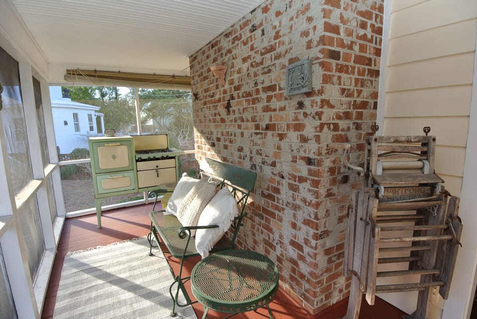 The laundry is accessed from the screen porch behind the white door.