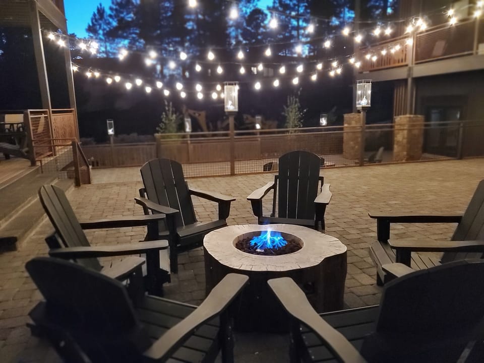 Enjoy evening conversation by the fire with gas lanterns and twinkle lights above