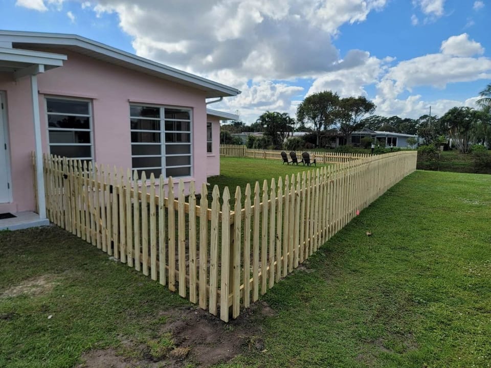 Side View of House & Picket Fence.  Completely enclosed w view of the waterway.