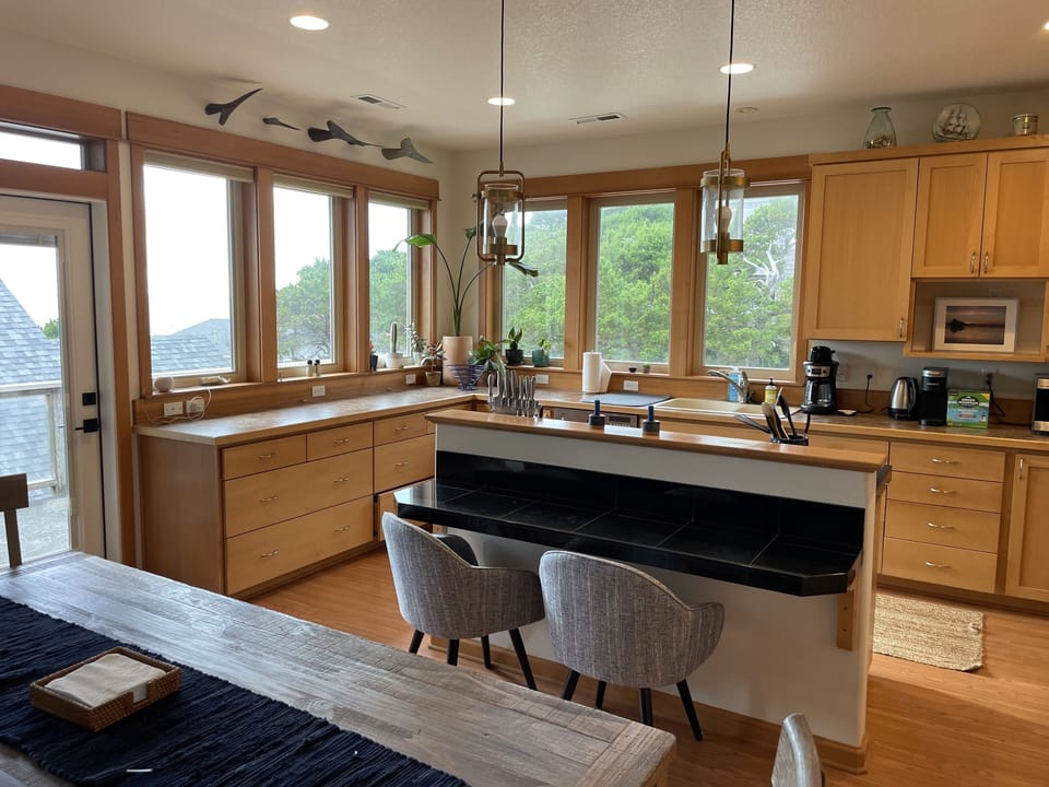 Bar top that seats 2 people, next to dining table 