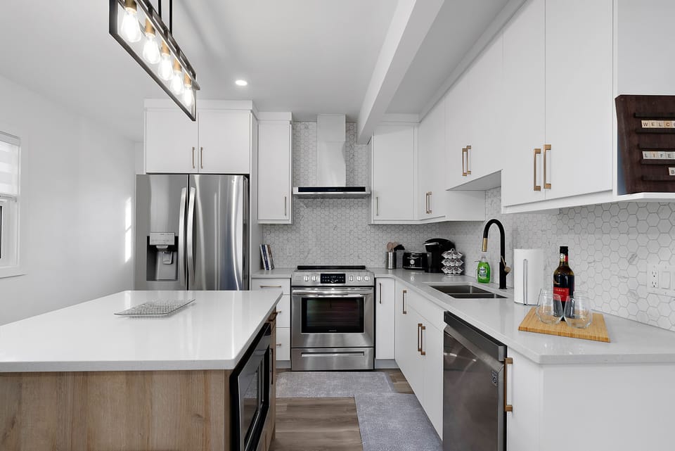 The kitchen boasts beautiful new stainless steel appliances.