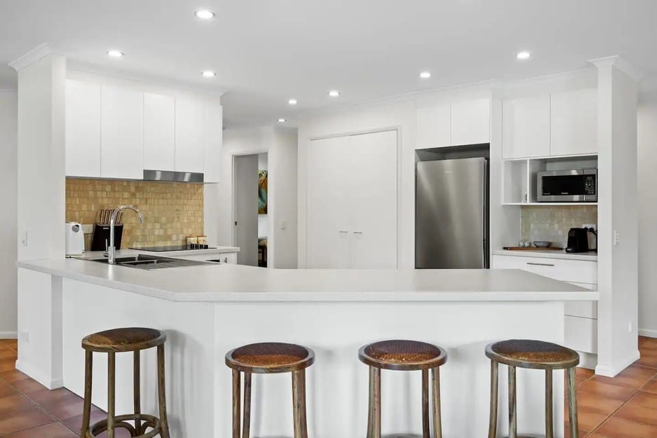 Kitchen equipped with dishwasher, microwave, oven, stove top and nespresso machi