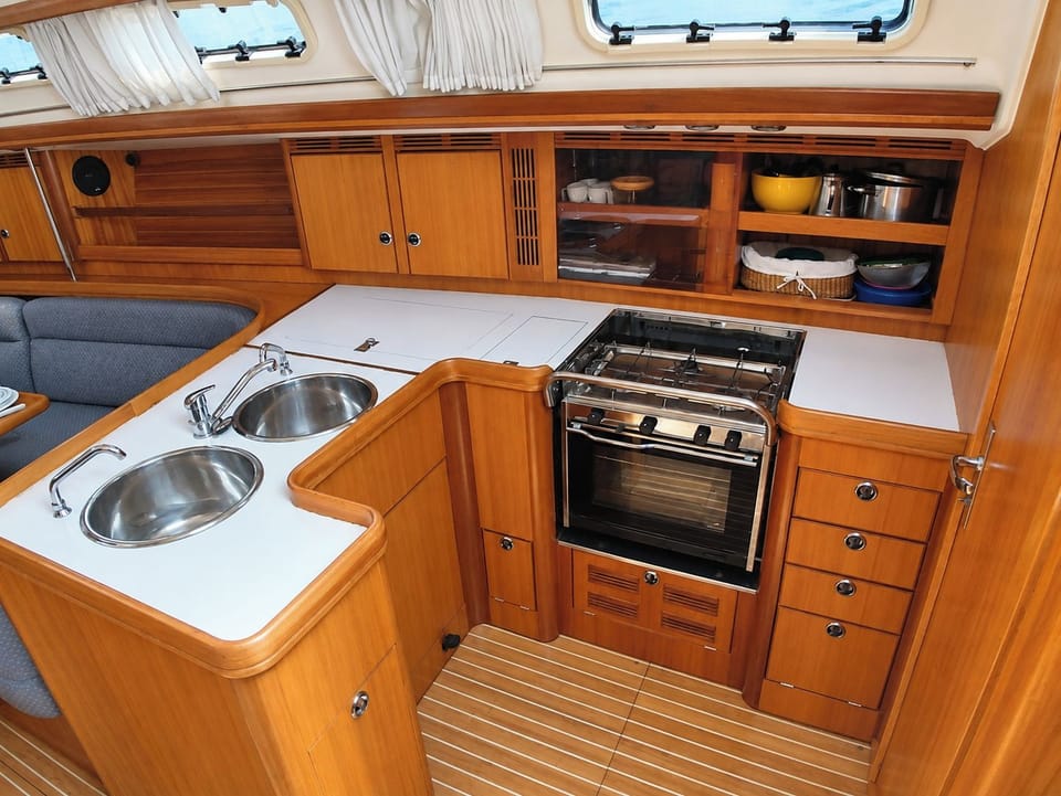 Compact marine bathroom with a sink, storage and practical onboard facilities.