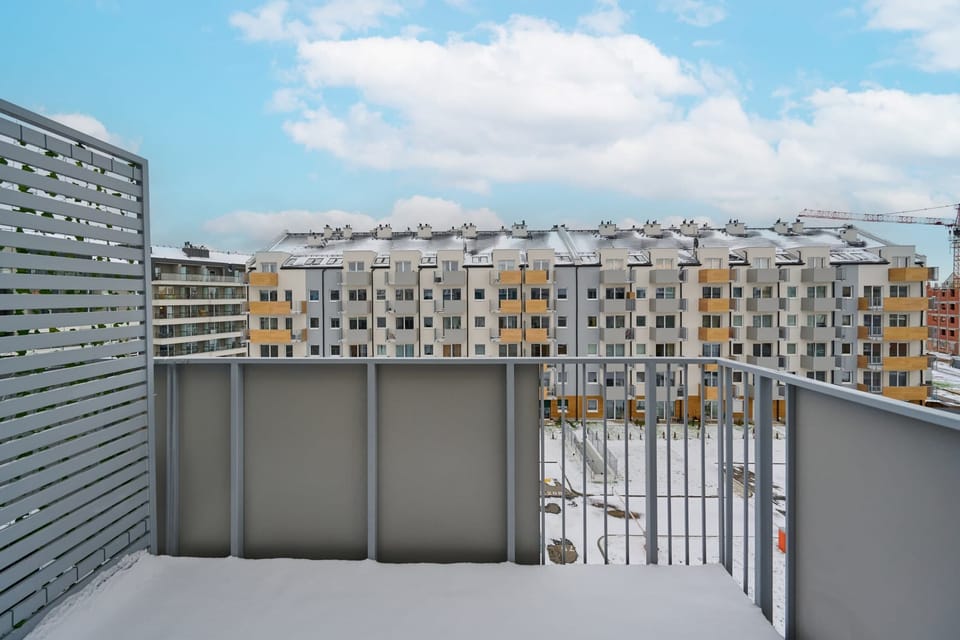 Spacious balcony with city view.