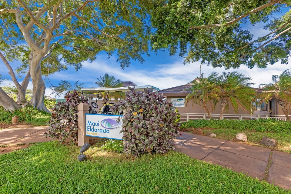 The welcoming entrance of Maui Eldorado features lush greenery and a private cabana shuttle, ensuring a luxurious and convenient beachside stay.